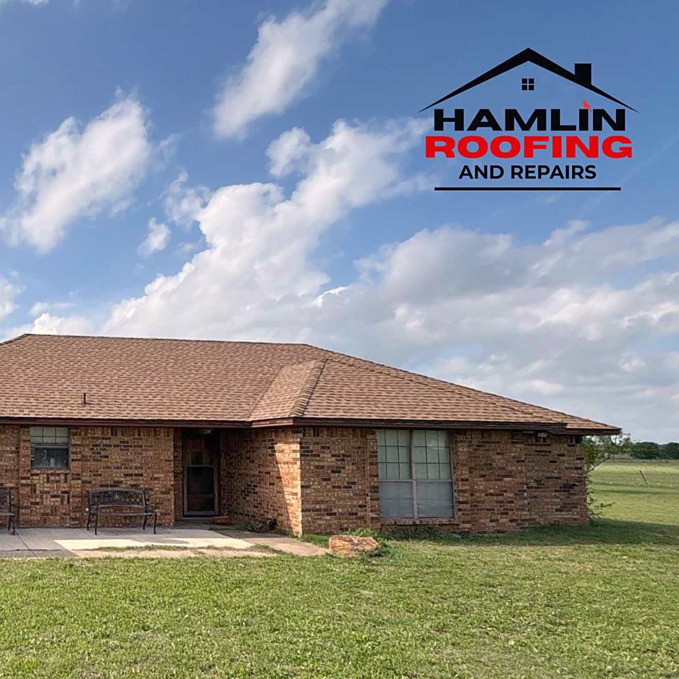 A brick ranch house on an open lot after a roof replacement